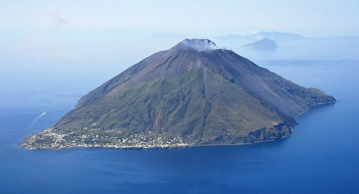 Stromboli at night from the air, one of the volcanoes in Volcano Guide